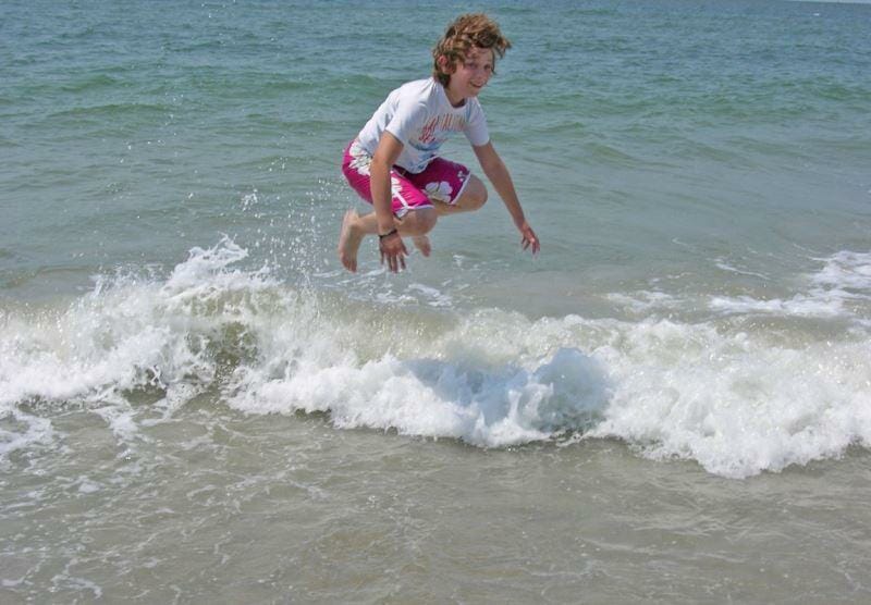 kids playing the waves, beach fun