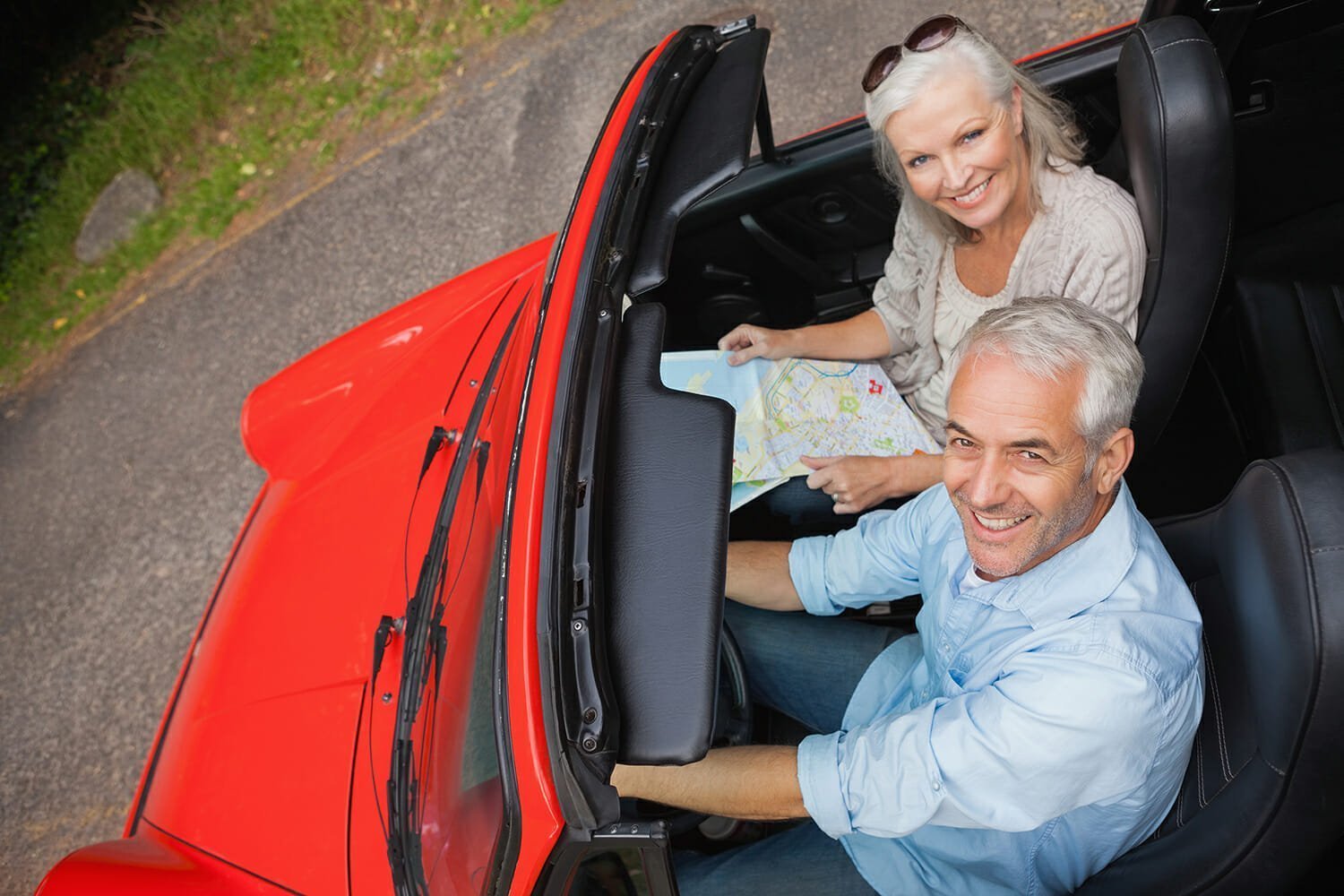 High angle view of smiling mature man having a ride with his wife
