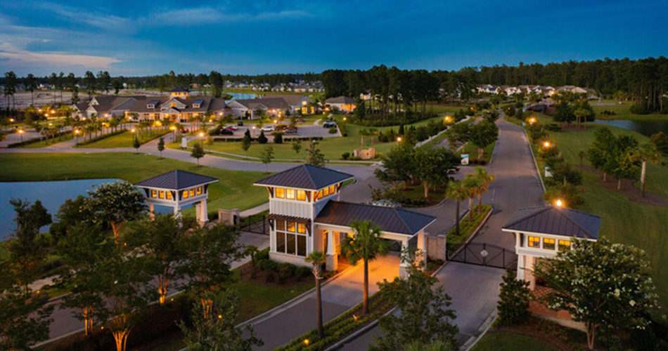 94340_Four Seasons at Lakes of Cane Bay_Community Aerial-1105244_Four Seasons at Lakes of Cane Bay_Gatehouse and Clubhouse at Twilight