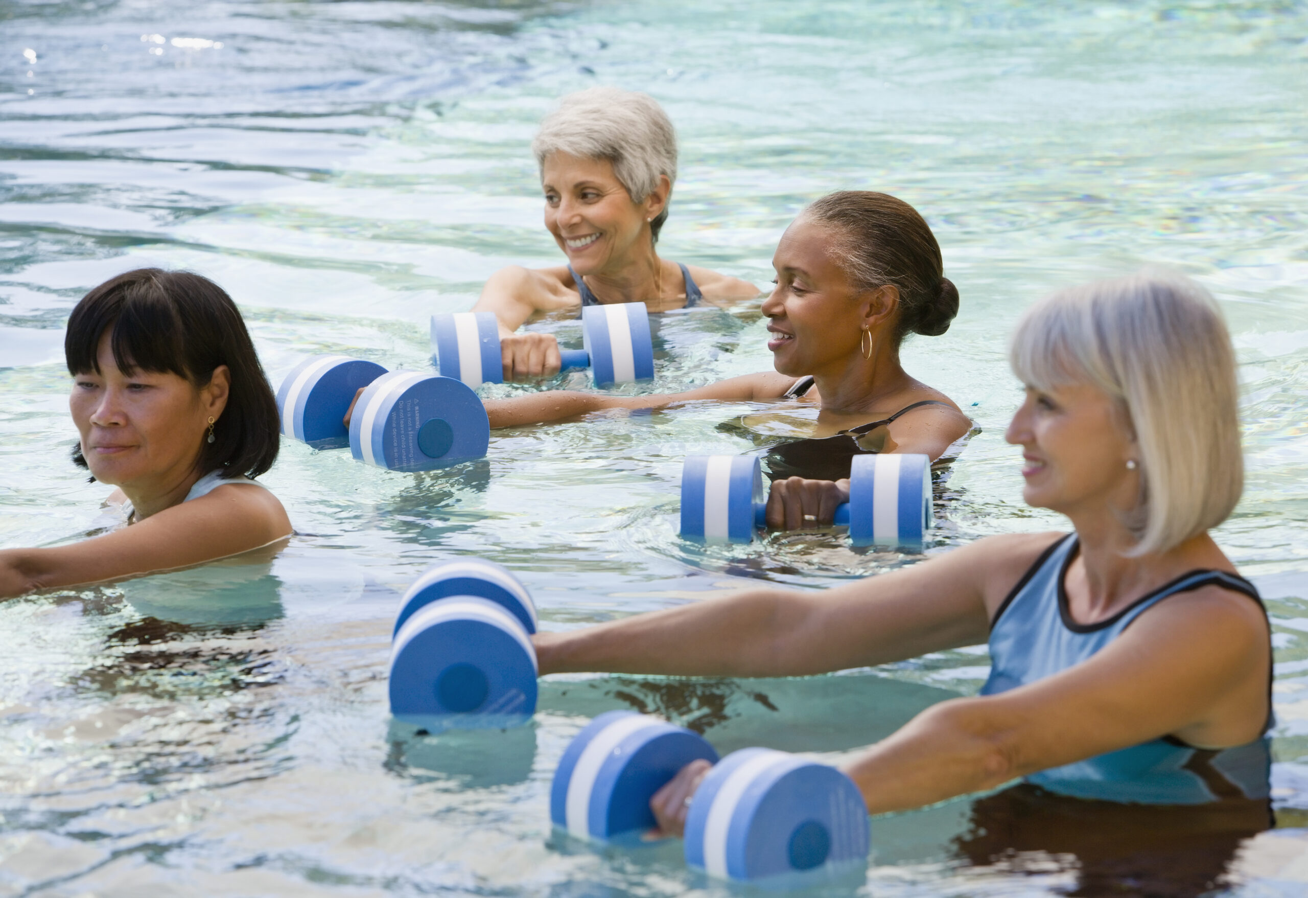 Multi-ethnic senior women exercising in swimming pool